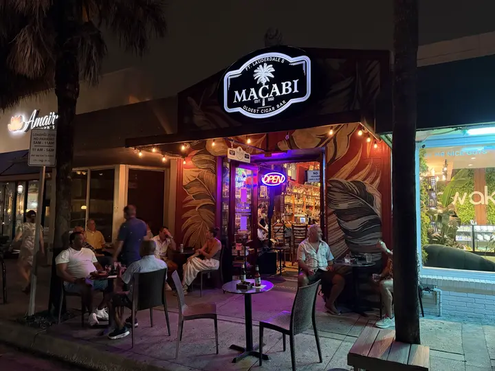 Guests enjoying the outdoor seating at Macabi Cigar Bar at night